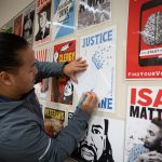 art project participant traces a poster